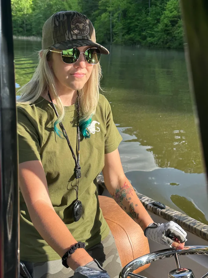 Gina at the helm of her boat on an NC lake