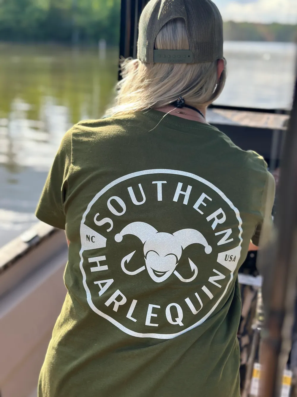 Gina wearing the Southern Harlequin logo tee on the lake